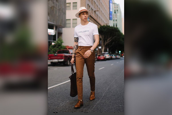 Man in white crew neck tshirt and brown pants standing on road during  daytime photo  Free Fashion Image on Unsplash