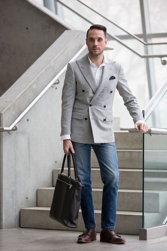 man wearing a grey double breasted blazer and jeans