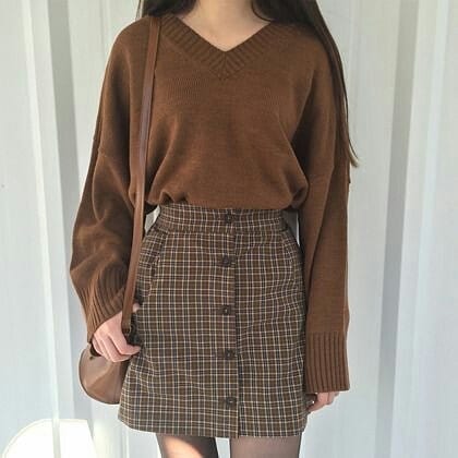 brown chequered skirt with a full sleeved sweatshirt