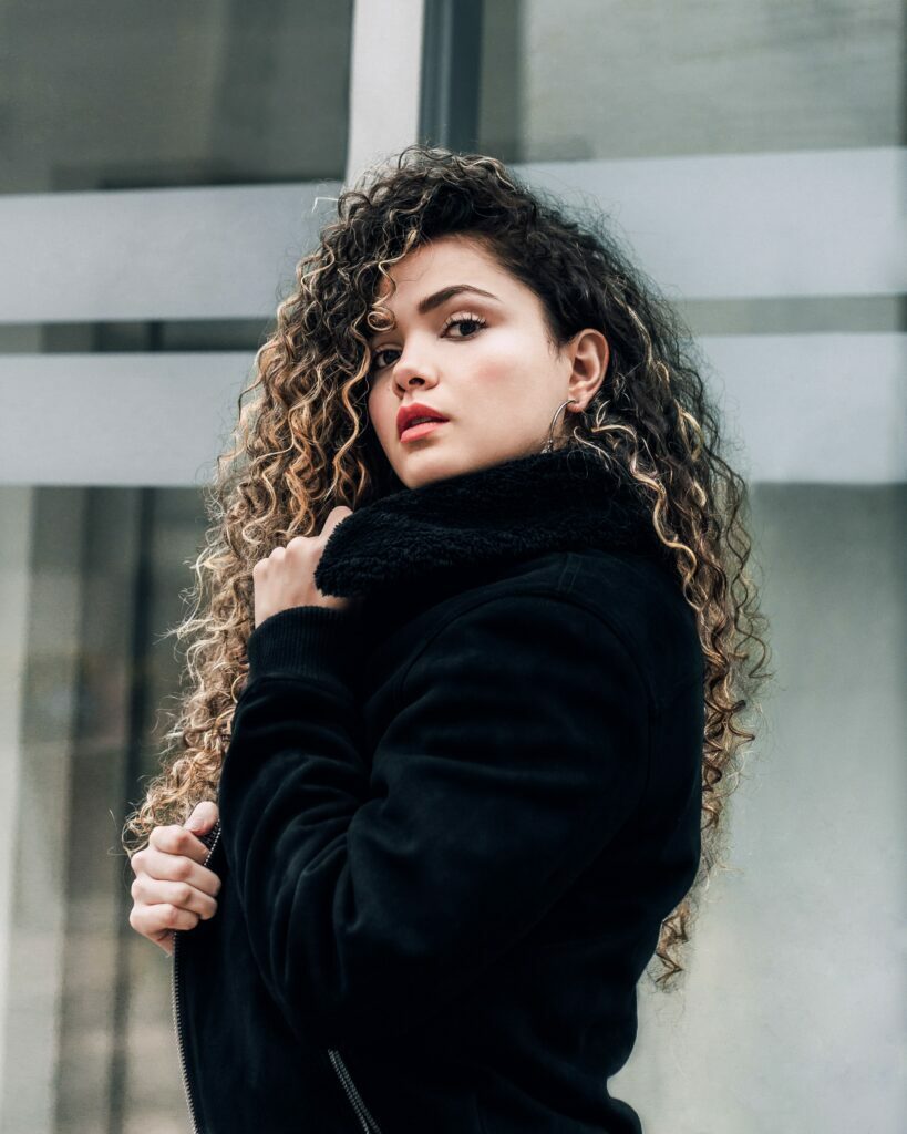 girl wearing a
black bomber jacket with a fur collar