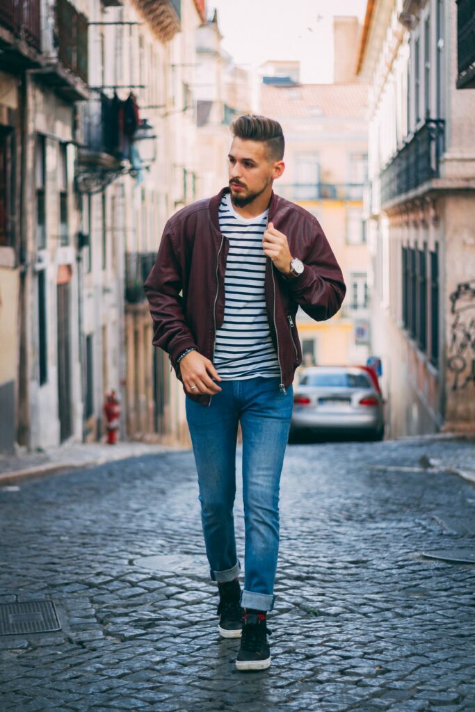 blue jeans and striped t-shirt outfit paired with a bomber jacket