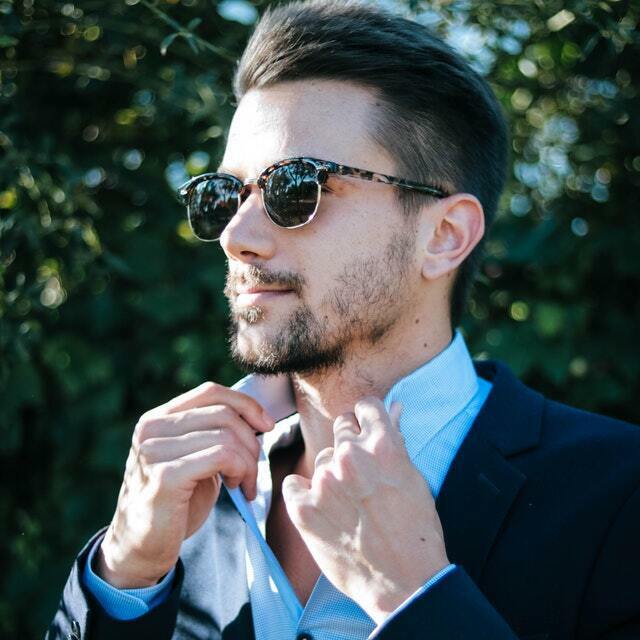 a stylish man wearing a navy blue suit
