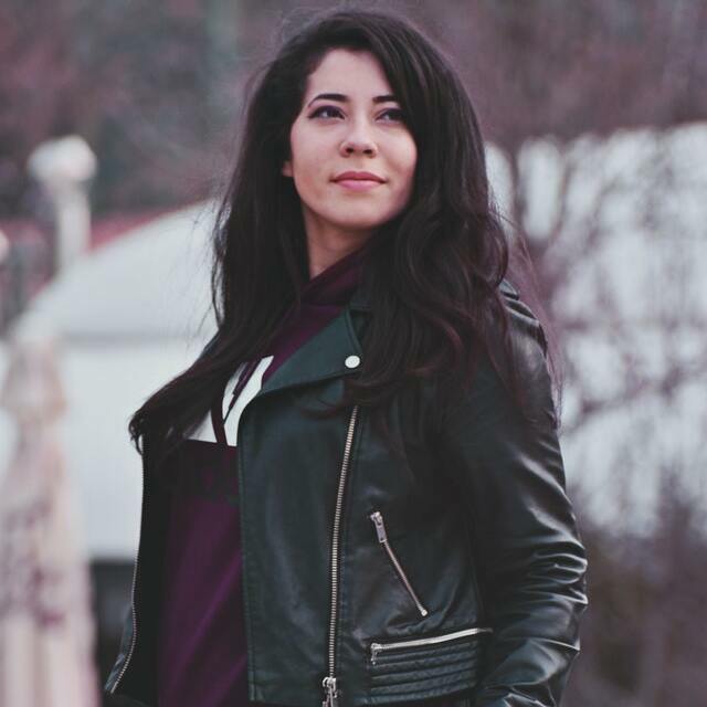woman wearing black biker jacket with black jeans