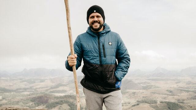 man wearing a hardshell jacket during mountaineering