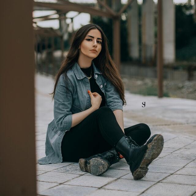 woman wearing a lightweight denim jacket and black jeans.