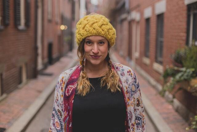 girl with braids wearing a yellow beanie