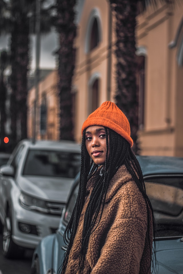 girl with box braids wearing a beanie