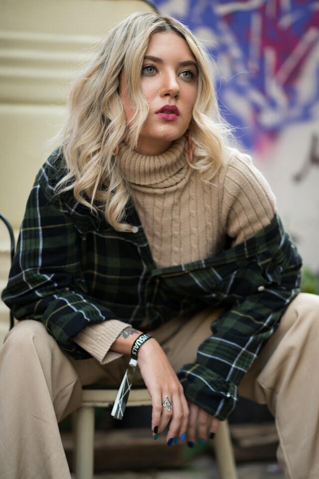 woman wearing a turtleneck and plaid shirt