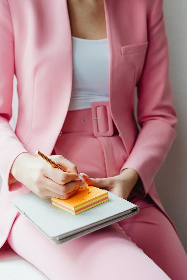 business woman wearing a pink pantsuit