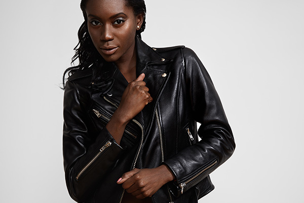 dark model is wearing the black moto leather jacket