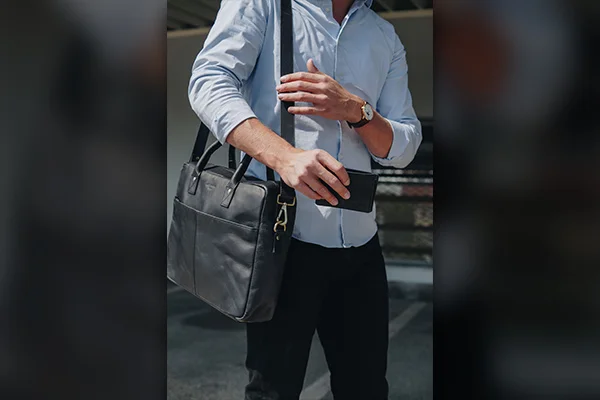 Man holding outlet purse