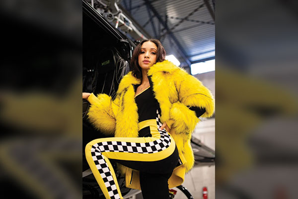 The yellow fur bomber jacket also looks good with a black jumpsuit. 