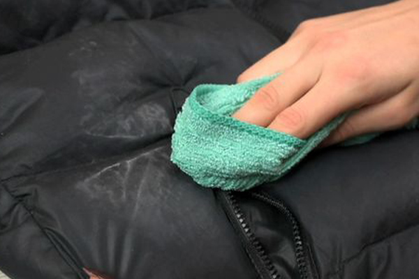 cleaning a puffer jacket using a piece of cloth